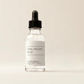 Aurelle Hydrating Hyaluronic Acid Serum bottle on ivory background